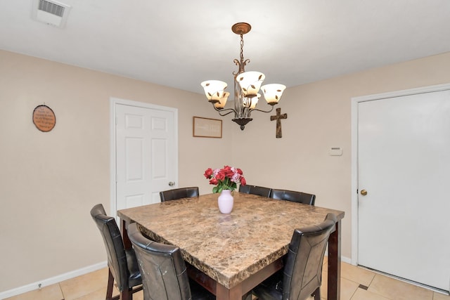 tiled dining area featuring a notable chandelier