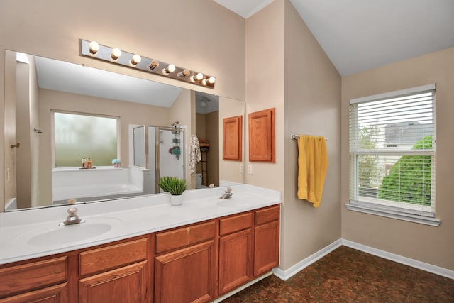 bathroom featuring separate shower and tub, vanity, and vaulted ceiling