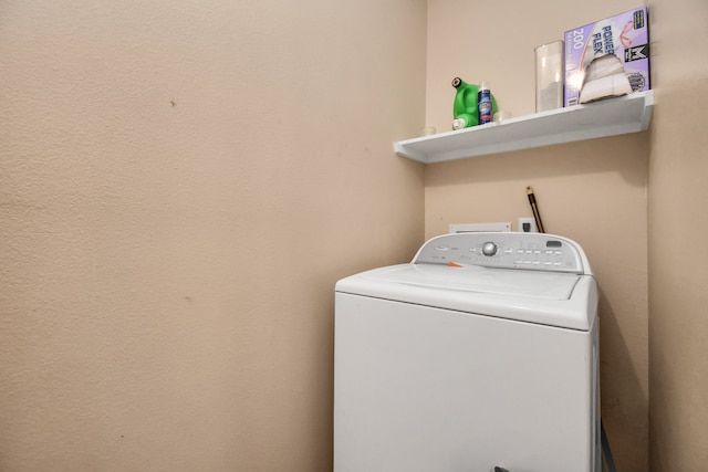 clothes washing area featuring washer / dryer