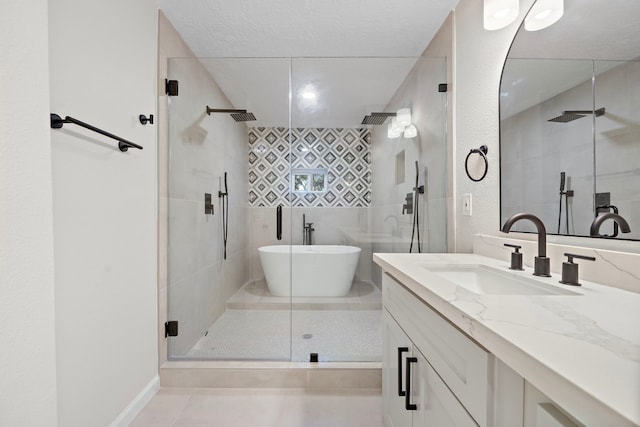 bathroom with vanity, tile patterned floors, independent shower and bath, and a textured ceiling