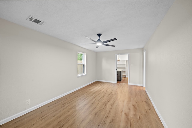 unfurnished living room featuring a textured ceiling, light wood-type flooring, and ceiling fan