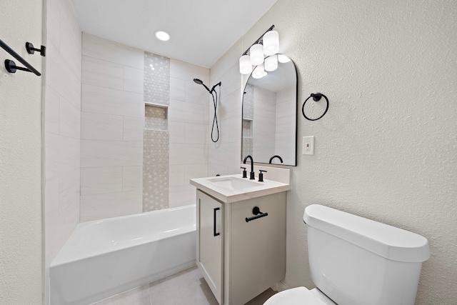 full bathroom featuring vanity, toilet, and tiled shower / bath