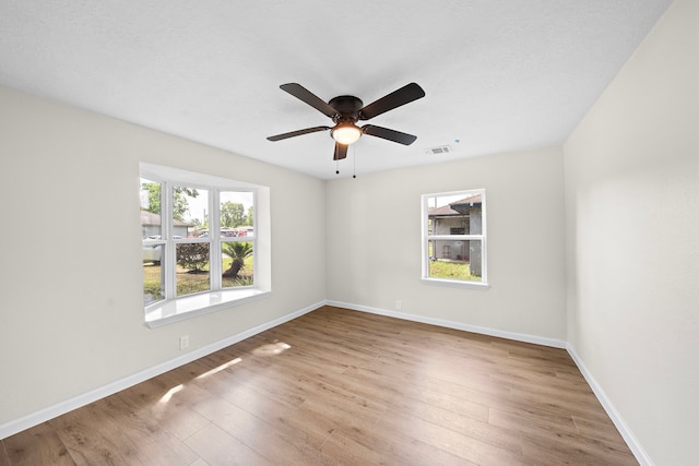 empty room with hardwood / wood-style flooring and ceiling fan