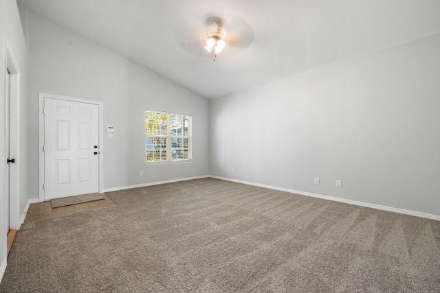 carpeted spare room featuring high vaulted ceiling and ceiling fan