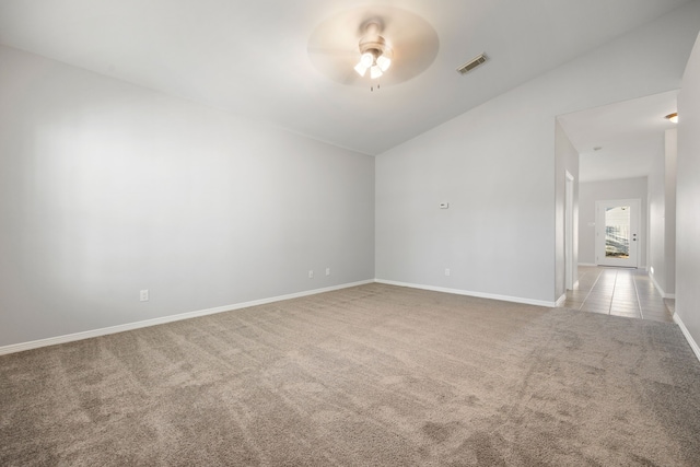 unfurnished room with lofted ceiling, light colored carpet, and ceiling fan