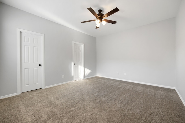 spare room with ceiling fan and carpet