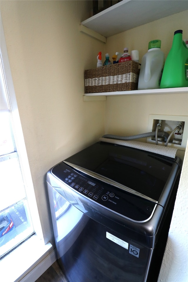 interior details with hookup for a washing machine and hardwood / wood-style floors