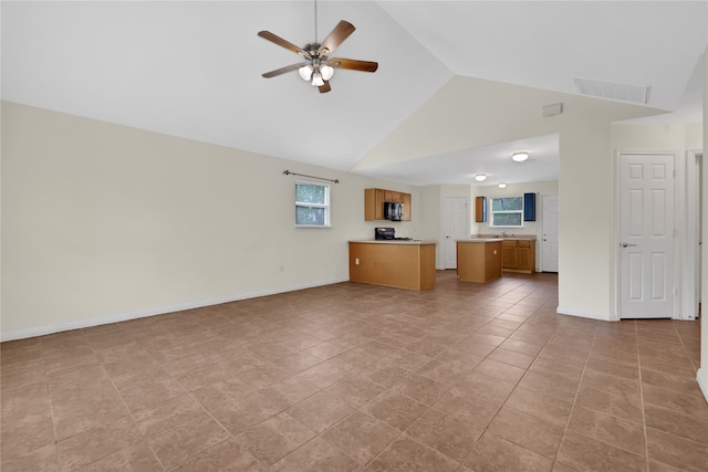 unfurnished living room featuring ceiling fan, high vaulted ceiling, and light tile patterned floors