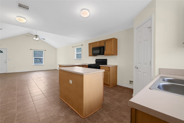 kitchen featuring dark tile patterned flooring, ceiling fan, black appliances, and vaulted ceiling