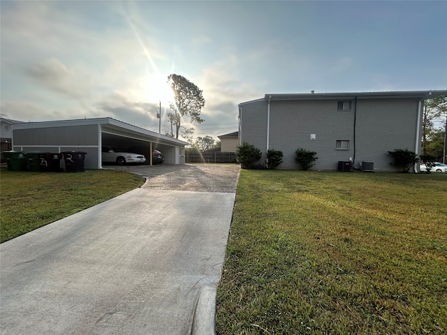 view of side of property featuring a yard and central air condition unit