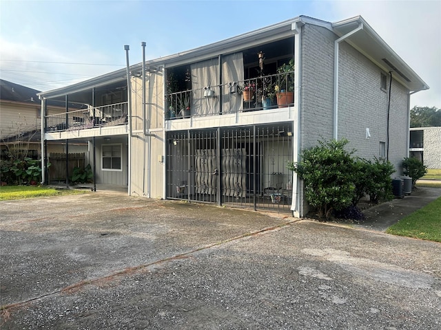 view of property featuring central AC and driveway