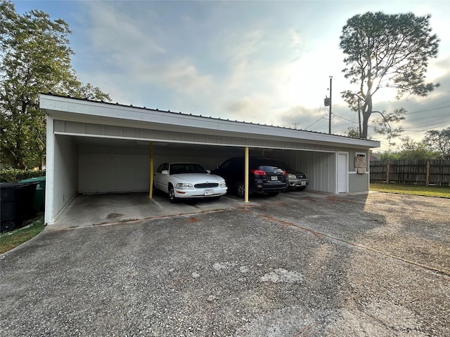 view of vehicle parking with fence