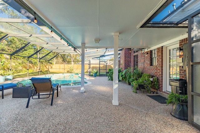 view of patio / terrace featuring a fenced in pool and glass enclosure