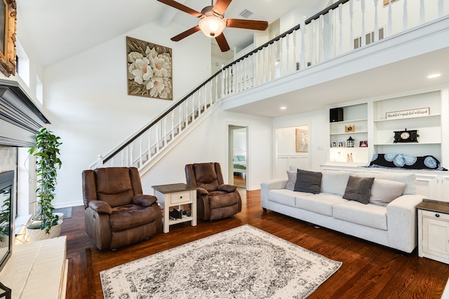 living room with beam ceiling, dark hardwood / wood-style flooring, high vaulted ceiling, and ceiling fan