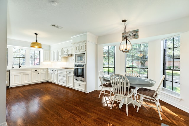 kitchen featuring white cabinets, stainless steel appliances, and a healthy amount of sunlight