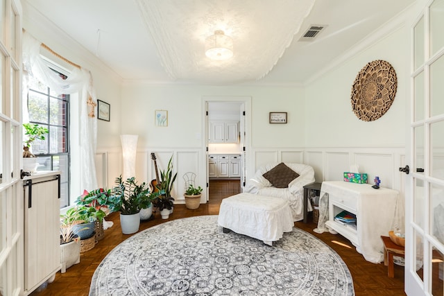 sitting room with french doors and ornamental molding