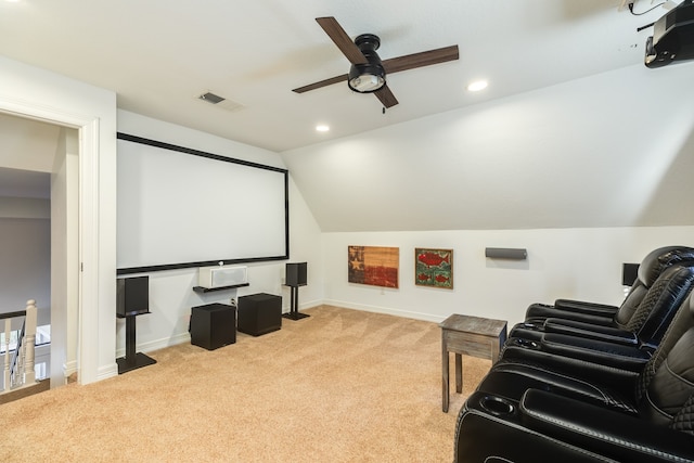 home theater with light carpet, ceiling fan, and vaulted ceiling