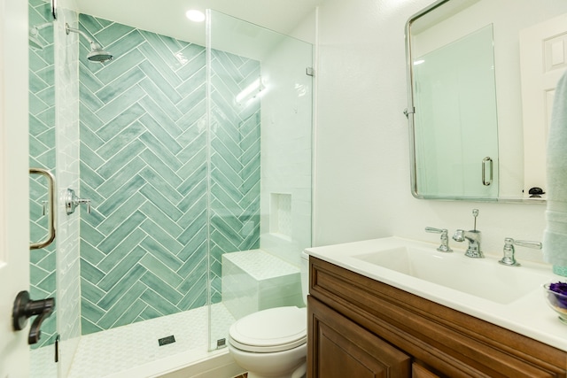 bathroom with vanity, toilet, and walk in shower