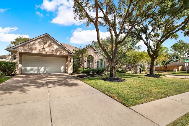 view of front of property featuring a garage and a front lawn