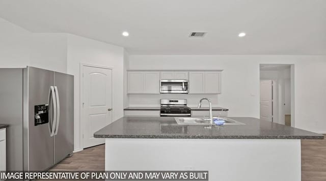 kitchen featuring stainless steel appliances, white cabinets, and a kitchen island with sink