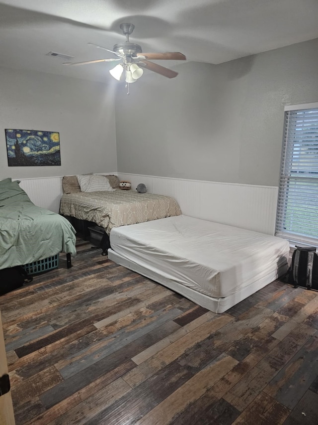 bedroom featuring dark wood-type flooring and ceiling fan