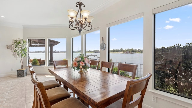 dining space featuring a water view, ornamental molding, light tile patterned floors, and a chandelier