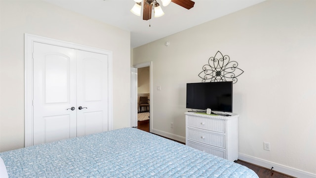 bedroom featuring dark hardwood / wood-style flooring, a closet, and ceiling fan