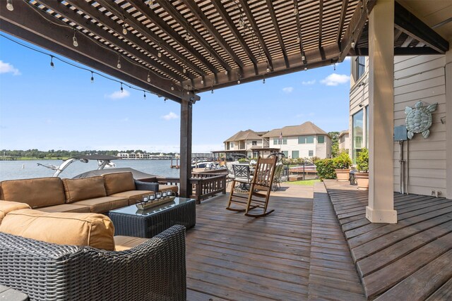 wooden terrace featuring a water view and an outdoor hangout area