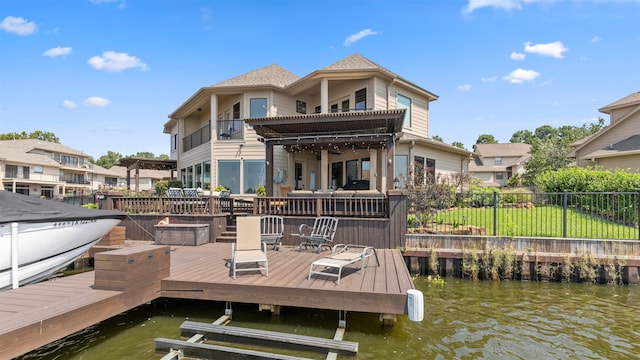 dock area featuring a balcony and a water view