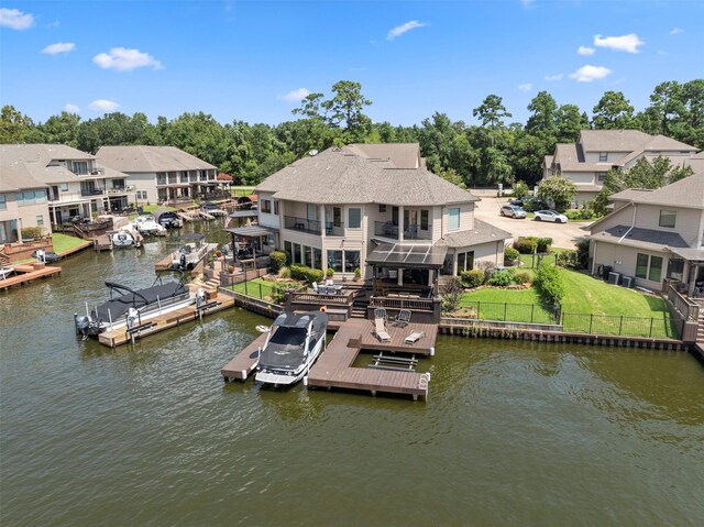 dock area with a deck with water view and a lawn