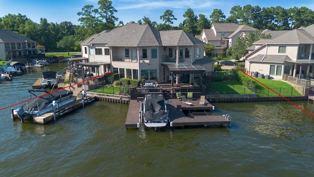 view of dock featuring a water view, a balcony, and a yard