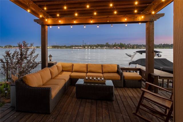 deck at dusk featuring a water view and an outdoor hangout area