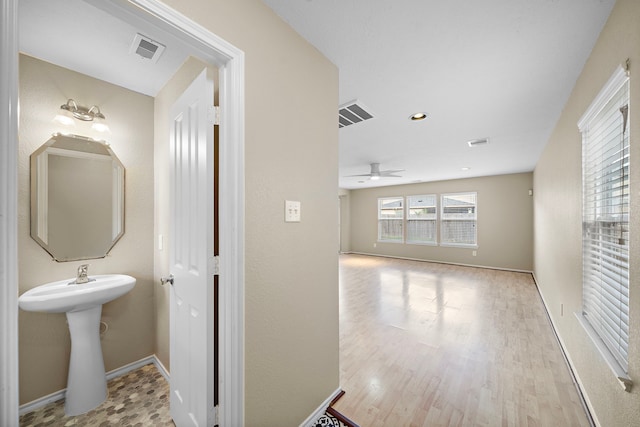 bathroom featuring hardwood / wood-style flooring and ceiling fan