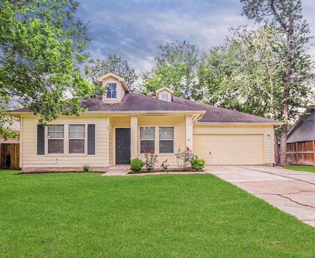 view of front of house featuring a front lawn and a garage