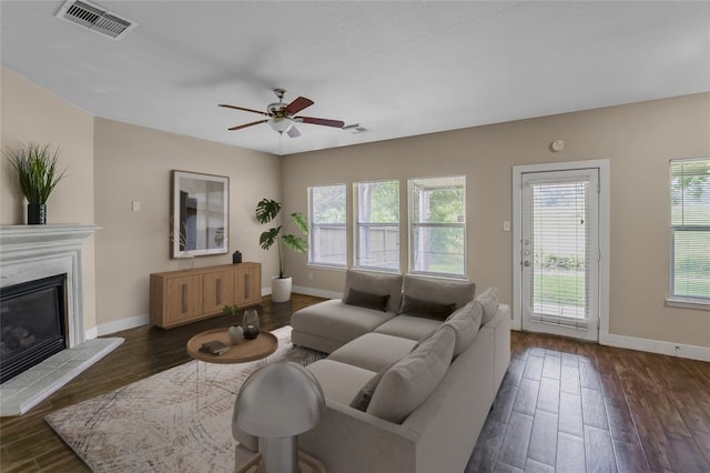 living room with ceiling fan and dark hardwood / wood-style flooring