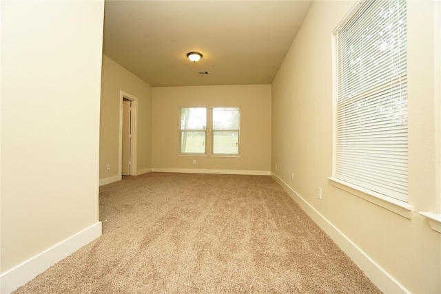 unfurnished room with light colored carpet