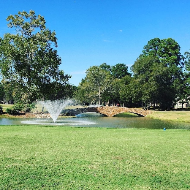 view of community featuring a yard and a water view