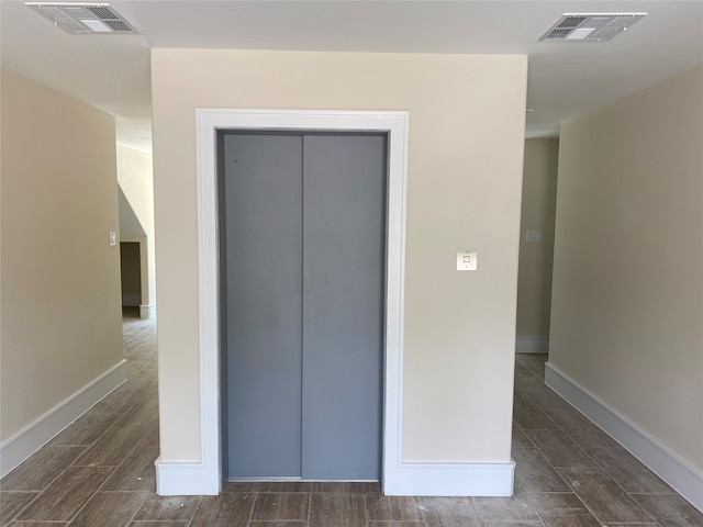 unfurnished bedroom with a closet and dark hardwood / wood-style floors