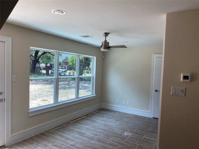 spare room featuring dark hardwood / wood-style flooring and ceiling fan