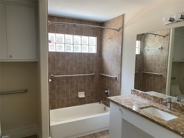 bathroom with vanity and tiled shower / bath