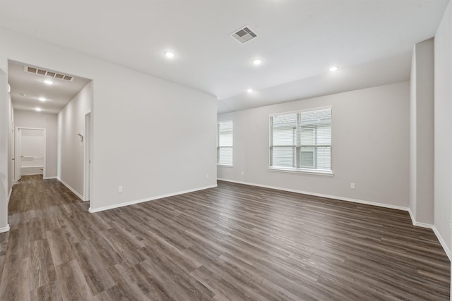 unfurnished room with dark wood-type flooring