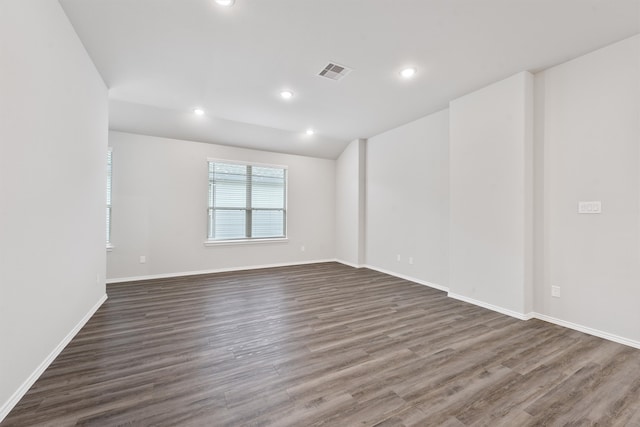 spare room with dark hardwood / wood-style flooring