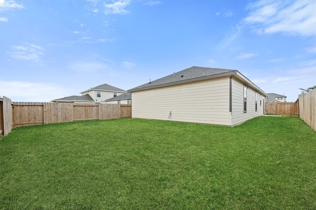 rear view of property featuring a lawn