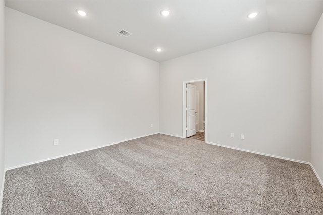 empty room featuring lofted ceiling and carpet floors