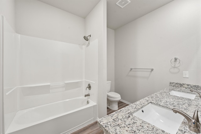 full bathroom featuring vanity, toilet, tub / shower combination, and hardwood / wood-style floors