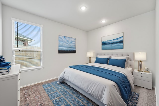 bedroom featuring multiple windows and dark carpet