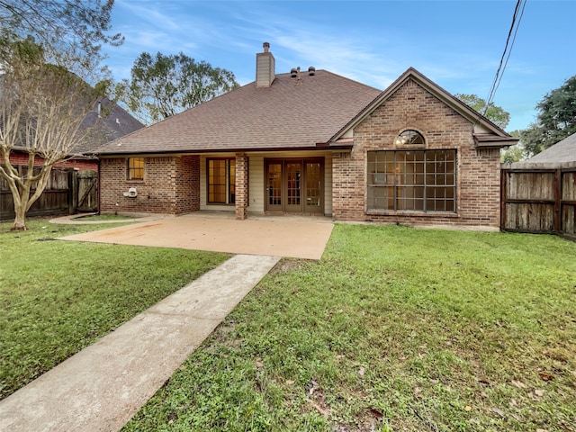 back of property featuring a patio and a yard