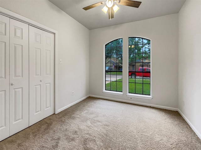 unfurnished bedroom featuring a closet, ceiling fan, and carpet floors