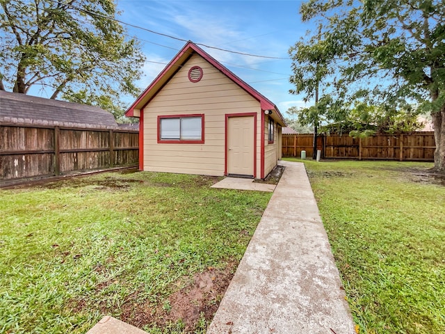 view of outbuilding with a yard