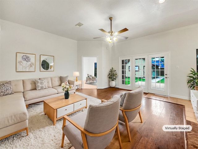 living room with french doors, light wood-type flooring, ornamental molding, and ceiling fan